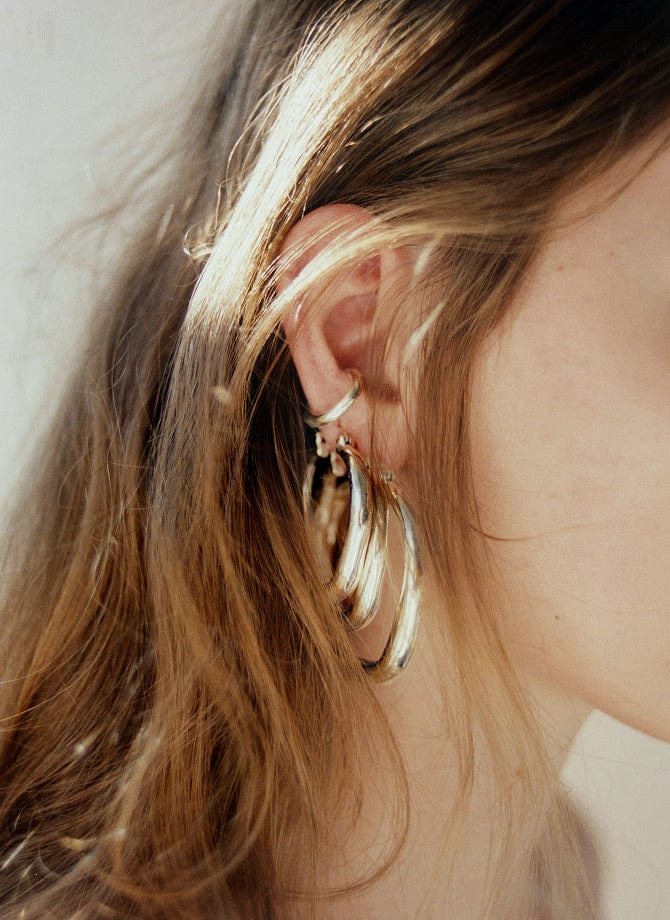 Aje campaign close up of a gold hoop earring